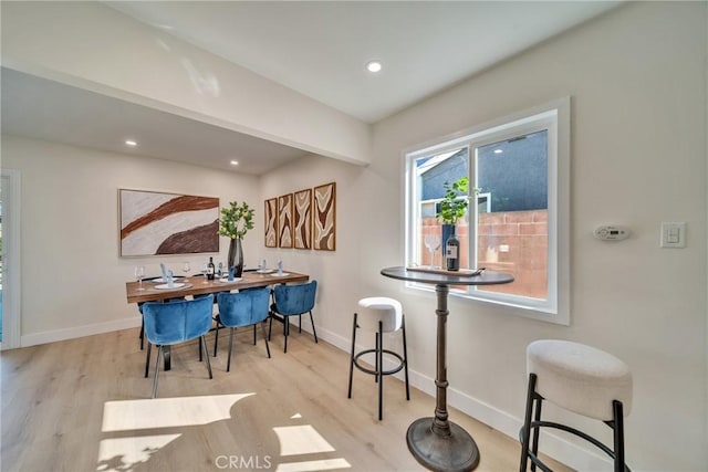 dining room with wood finished floors, baseboards, and recessed lighting