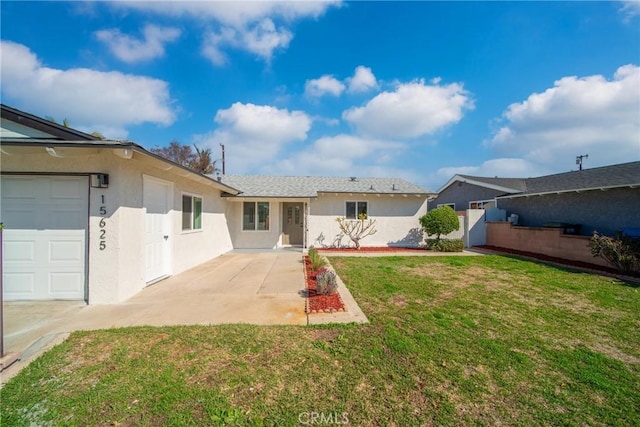 exterior space with stucco siding, fence, and a lawn