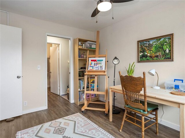 office area featuring ceiling fan, baseboards, and wood finished floors