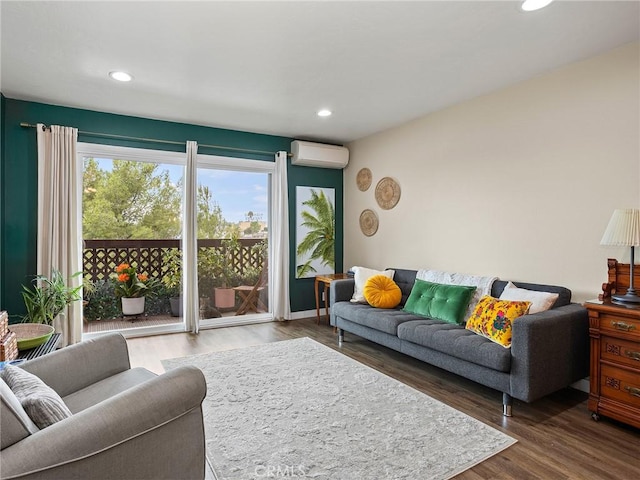 living area with recessed lighting, wood finished floors, and a wall mounted air conditioner