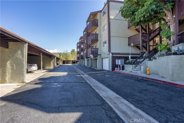 view of street with community garages and stairs