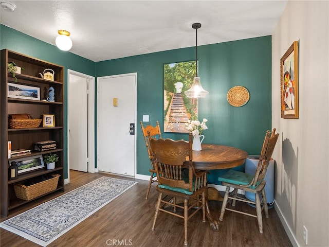 dining space with wood finished floors and baseboards