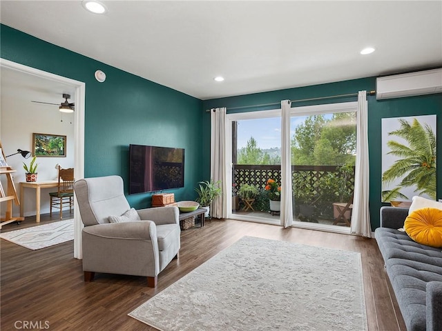 living room with an AC wall unit, recessed lighting, and wood finished floors