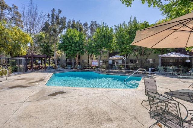 pool featuring a patio area and fence