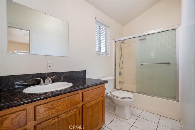 full bath featuring toilet, vaulted ceiling, shower / bath combination with glass door, tile patterned floors, and vanity