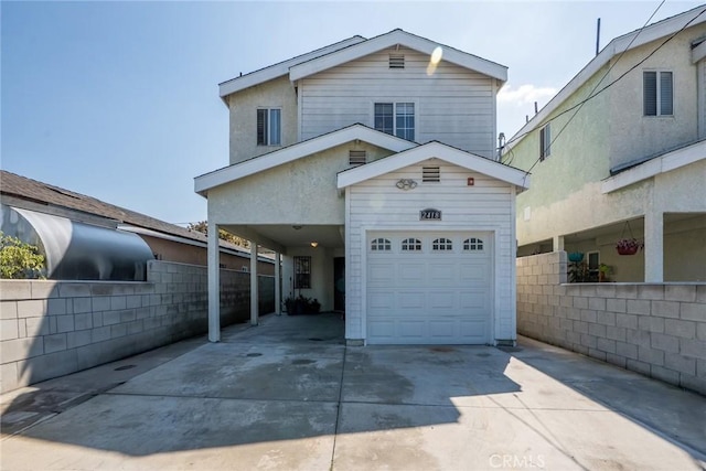 traditional-style home featuring a garage and driveway