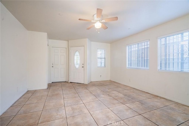 foyer entrance featuring light tile patterned floors and a ceiling fan