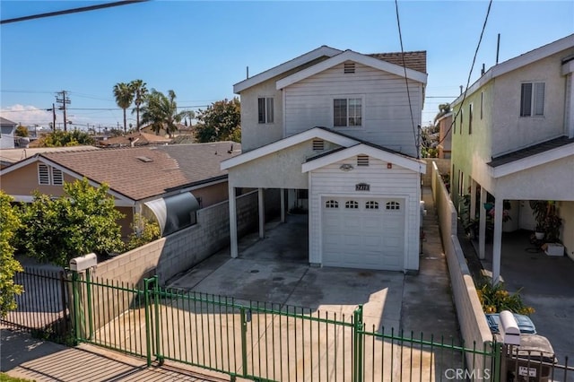 view of front of house featuring concrete driveway, a gate, a garage, and a fenced front yard