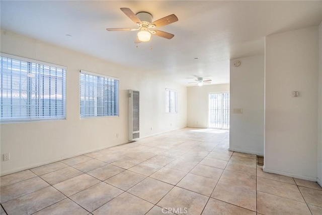 empty room with light tile patterned floors and ceiling fan