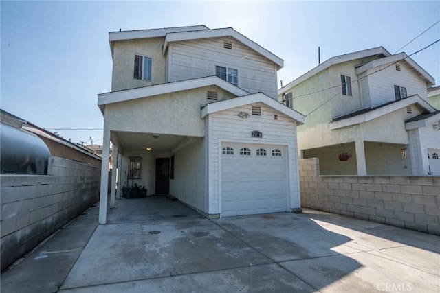 view of front of property featuring concrete driveway and an attached garage