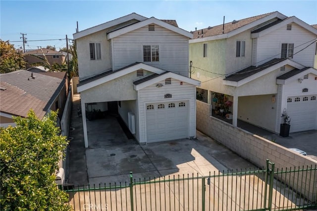 view of front facade with a fenced front yard, stucco siding, concrete driveway, and a garage