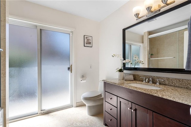 bathroom featuring tile patterned flooring, toilet, vanity, and a shower with shower door