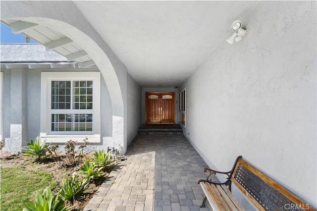 view of exterior entry featuring stucco siding