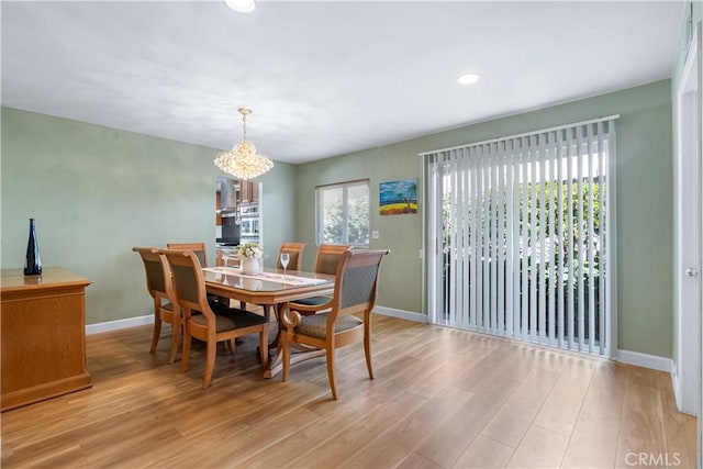 dining space featuring a chandelier, recessed lighting, baseboards, and light wood-style floors