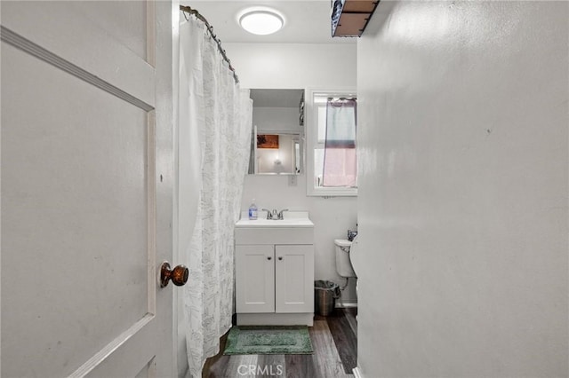 full bathroom featuring vanity, toilet, and wood finished floors