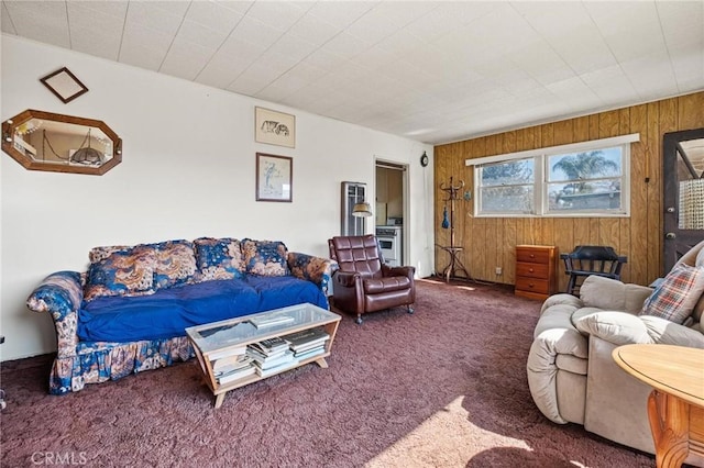 living room featuring carpet flooring and wooden walls