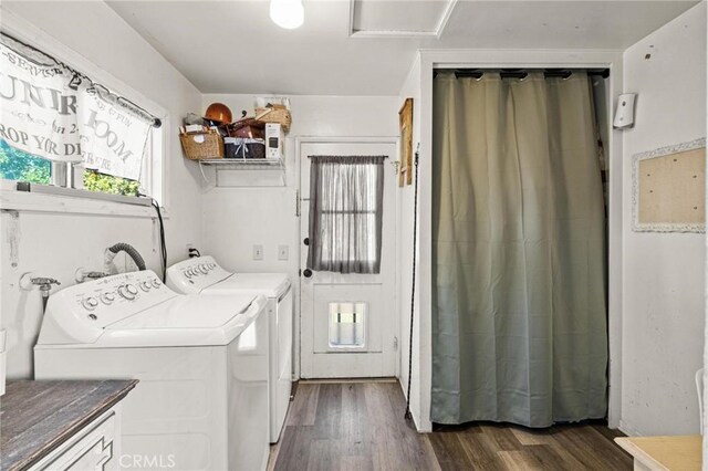 washroom with washing machine and dryer, dark wood finished floors, and laundry area