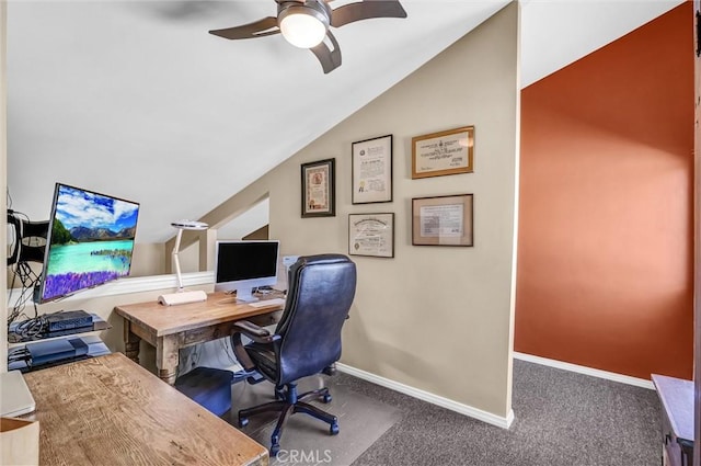 carpeted office space featuring lofted ceiling, a ceiling fan, and baseboards