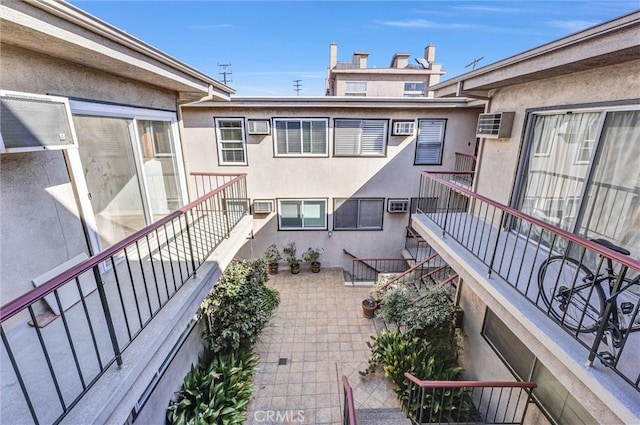 exterior space with an AC wall unit and stairway