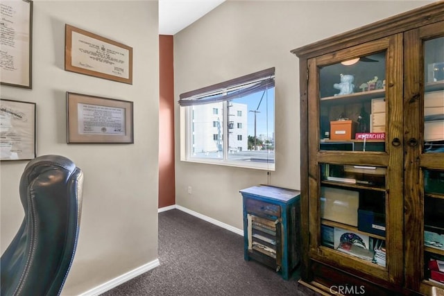 home office featuring dark carpet and baseboards