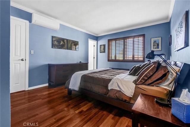 bedroom with wood finished floors, an AC wall unit, baseboards, and ornamental molding