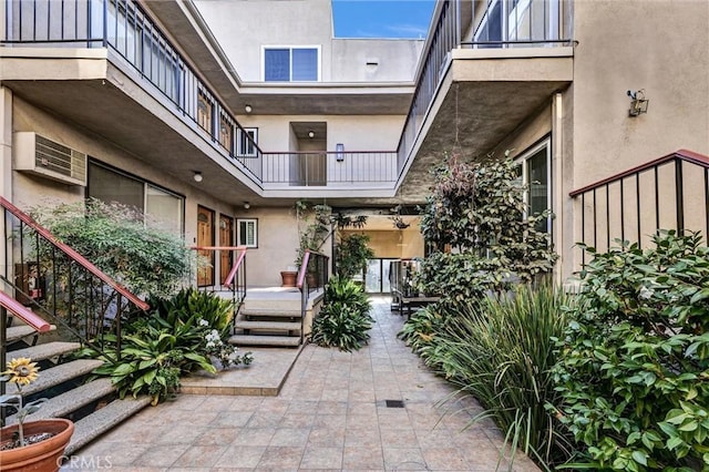 doorway to property featuring a patio area and stucco siding