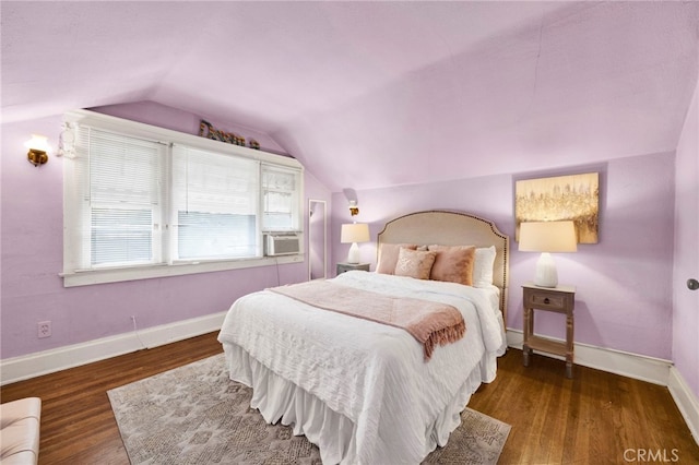 bedroom featuring vaulted ceiling, cooling unit, wood finished floors, and baseboards