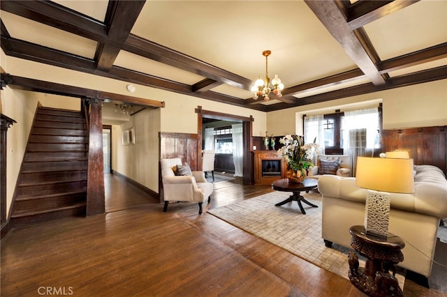 living area featuring a chandelier, stairs, beam ceiling, hardwood / wood-style flooring, and coffered ceiling