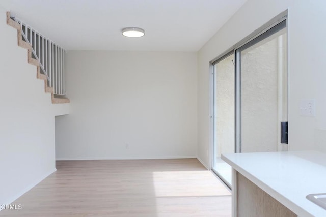 interior space featuring light wood-style floors and baseboards