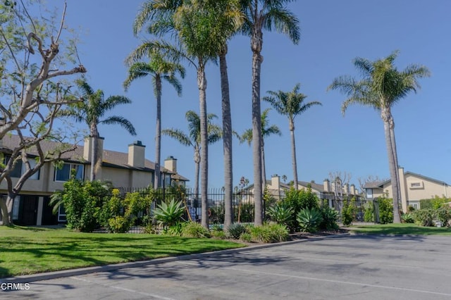 view of building exterior featuring a residential view and fence