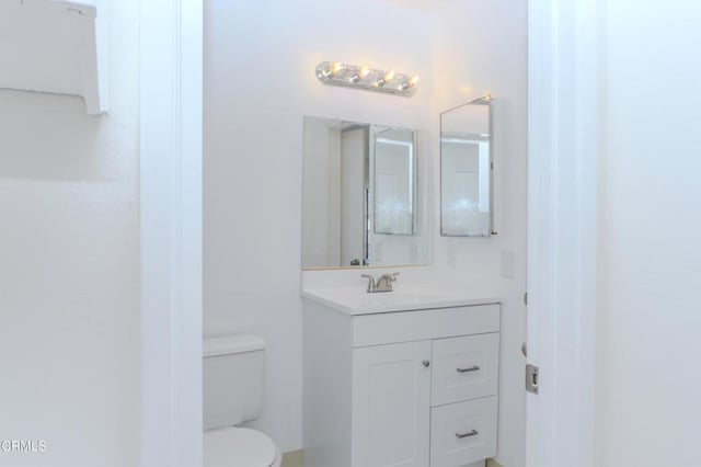 bathroom with toilet and vanity