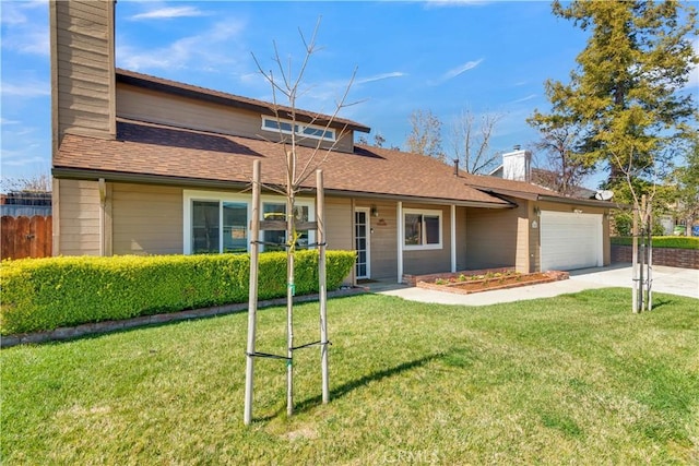 view of front facade with a shingled roof, a front lawn, concrete driveway, a chimney, and an attached garage