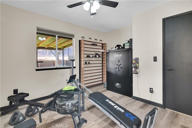 workout area featuring wood finished floors, baseboards, and ceiling fan