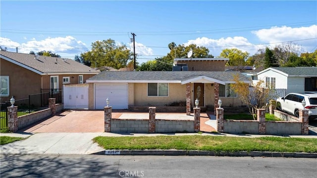 single story home with decorative driveway, fence, a garage, and stucco siding