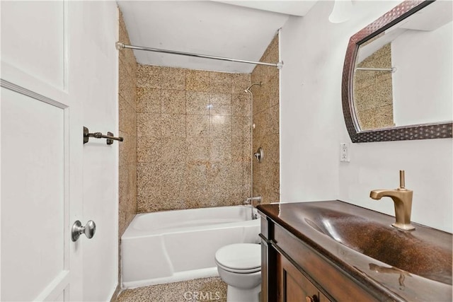 bathroom featuring toilet, vanity, and bathtub / shower combination
