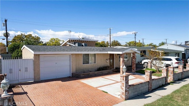 single story home featuring decorative driveway, fence, an attached garage, and stucco siding