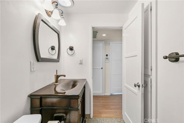 bathroom featuring visible vents, toilet, and vanity