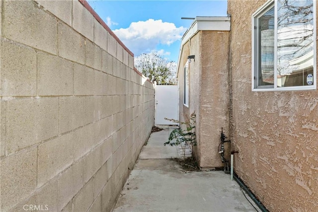 view of side of property featuring fence