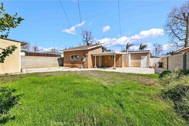 back of house with a yard, a patio, and a fenced backyard