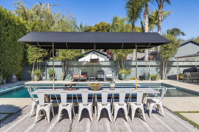 view of pool with a patio area and fence