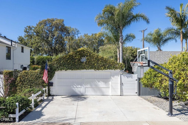 detached garage with fence and a gate