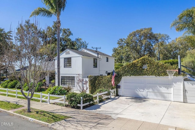 view of side of home with a garage and fence