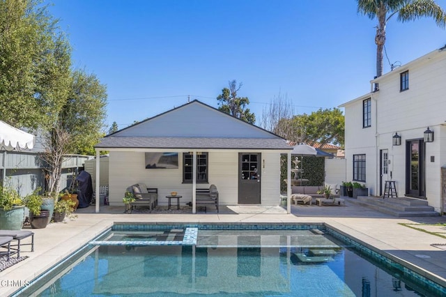 back of property featuring a pool with connected hot tub, fence, entry steps, an outdoor structure, and a patio