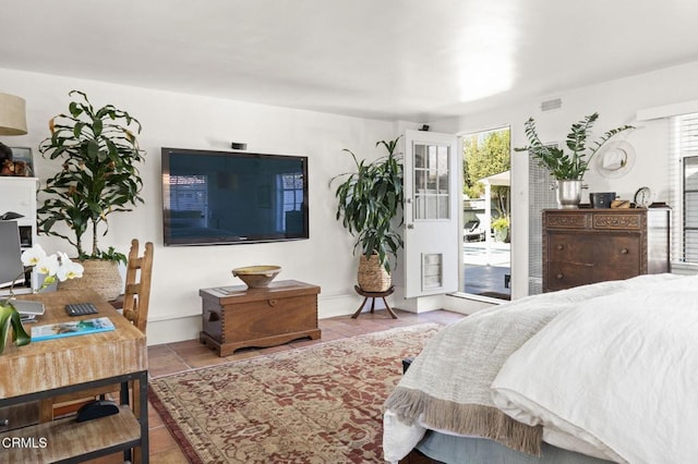 tiled bedroom with access to outside, baseboards, and visible vents