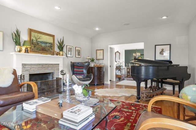 living room with recessed lighting, a fireplace, lofted ceiling, and wood finished floors