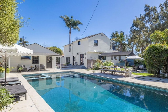 view of pool featuring a pool with connected hot tub and a patio area