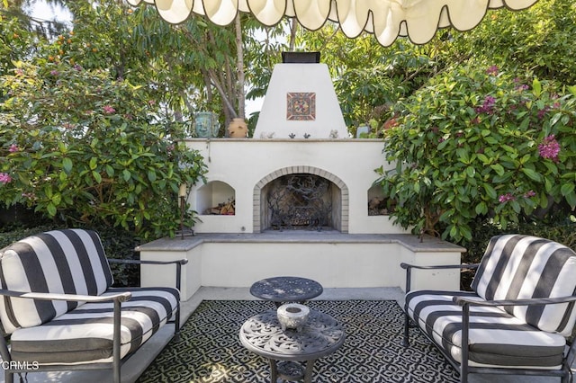 view of patio / terrace featuring an outdoor living space with a fireplace