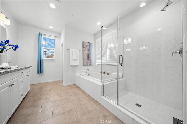 bathroom with tile patterned flooring, a bath, vanity, and a stall shower