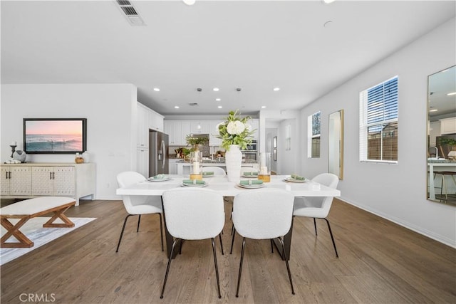 dining room featuring recessed lighting, visible vents, baseboards, and wood finished floors