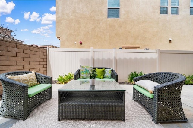 view of patio / terrace with an outdoor hangout area and fence